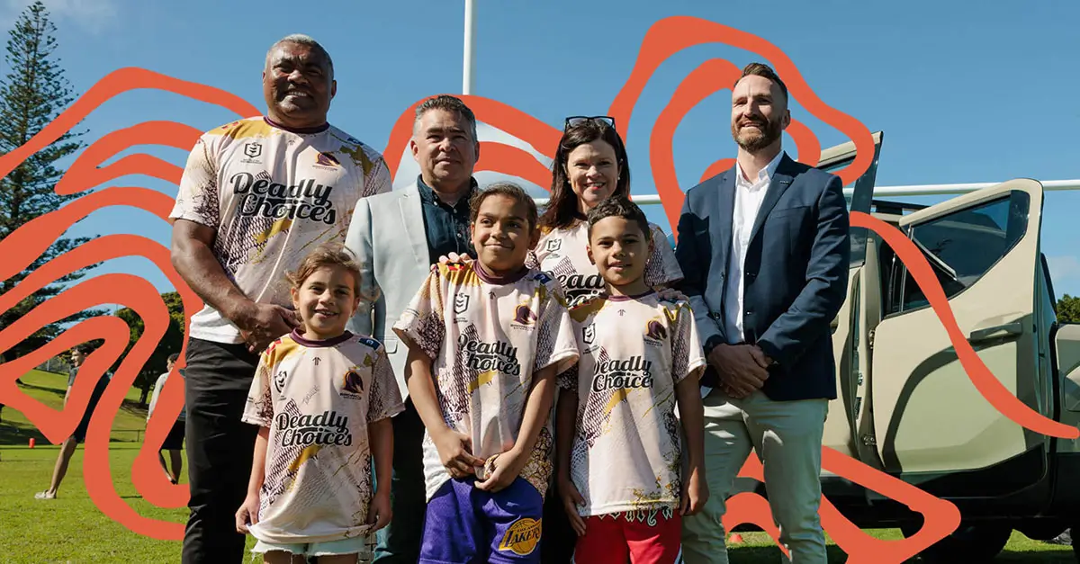 Family posing outdoors in sports jerseys