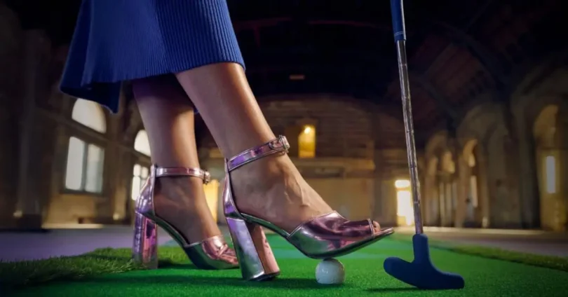Person putting a golf ball indoors