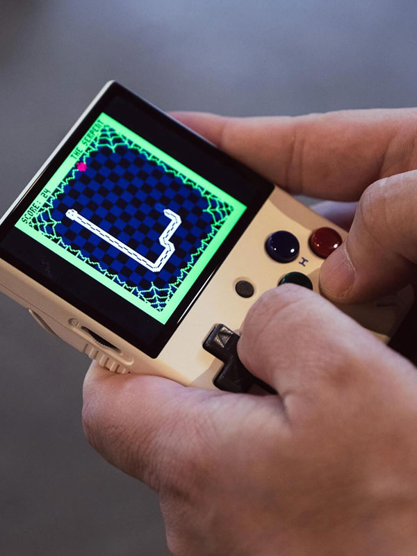 Hands holding a handheld gaming console