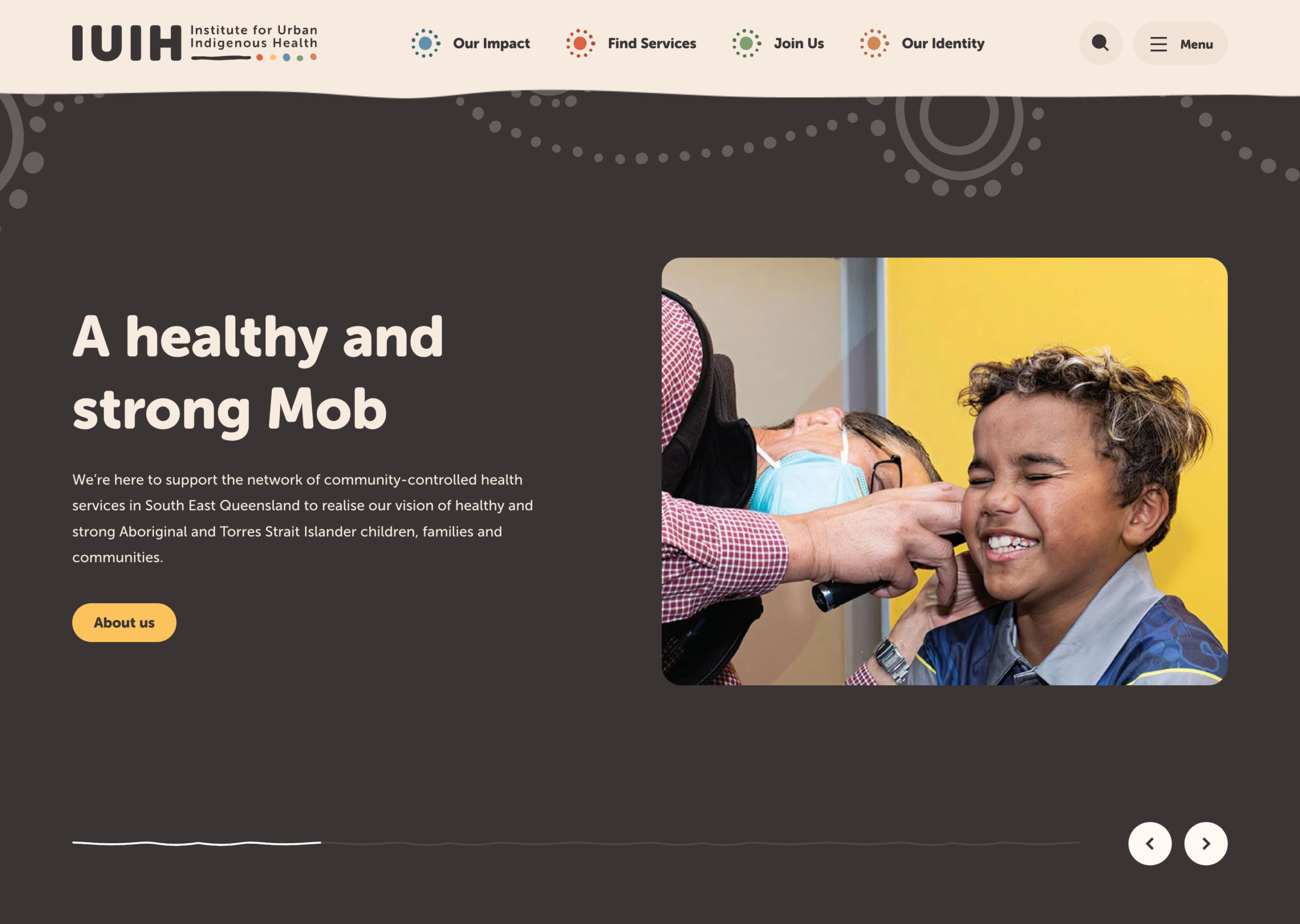 Screenshot of the Institute for Urban Indigenous Health website showing a smiling child receiving a medical check-up. The headline reads, "A healthy and strong Mob," with a button labeled "About us.